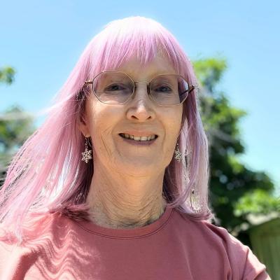 Image of woman with pink hair in sunshine