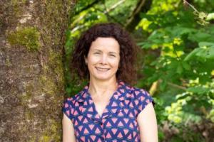 A head shot of Therese Ryan by a tree